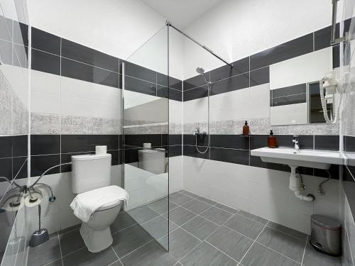 a bathroom with a toilet and a sink at Penzion MOVEINN in Prague