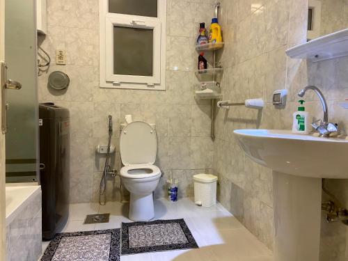 a bathroom with a toilet and a sink at Luxury Inn 3BR Amazing view in Madinaty B2 in Madinaty