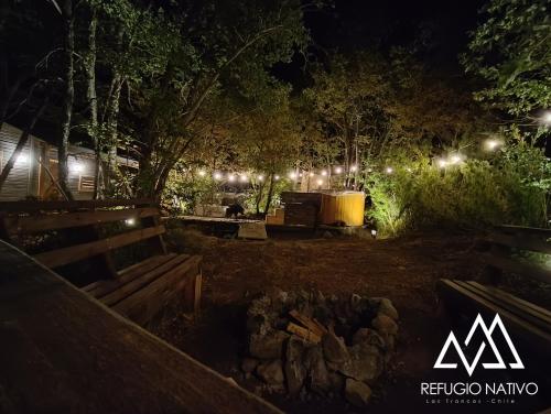 a park at night with benches and lights at Refugio Nativo in Nevados de Chillan