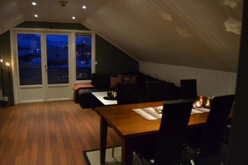 a living room with a table and a couch at Arctic Sea house in Svensby