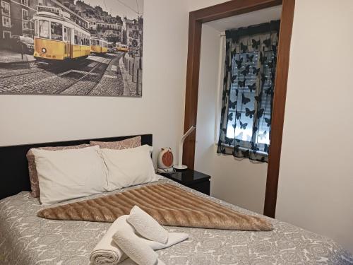 a bedroom with a bed with two towels on it at Appartement Lisbonne Estrela in Lisbon