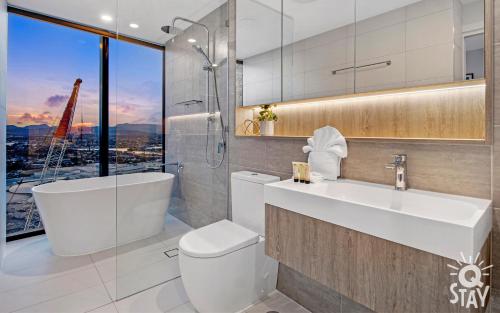 a bathroom with a sink and a toilet and a window at 3 Bedroom Private Apartments at Casino - Q Stay in Gold Coast