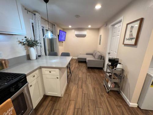 a kitchen with a counter top and a living room at La Casita de Whittier, Private Unit w/patio area, Disney, Biola, Knotts in Whittier