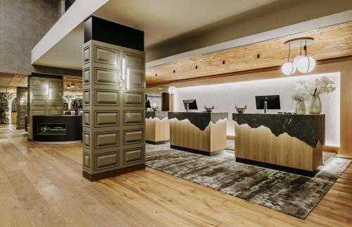 a hair salon with a bar in the middle of a room at Grand Tirolia Kitzb&uuml;hel - Member of Hommage Luxury Hotels Collection in Kitzb&uuml;hel