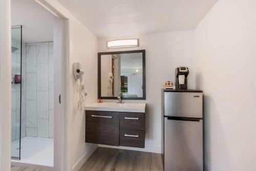 a bathroom with a refrigerator and a sink and a shower at SureStay Plus Hotel by Best Western Scottsdale North in Scottsdale