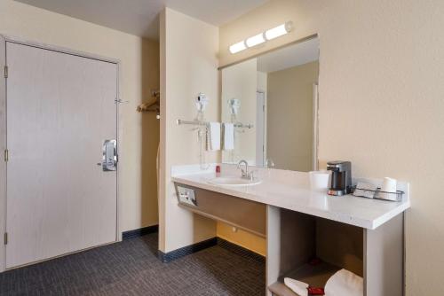 a bathroom with a sink and a mirror at SureStay Hotel by Best Western Wells in Wells