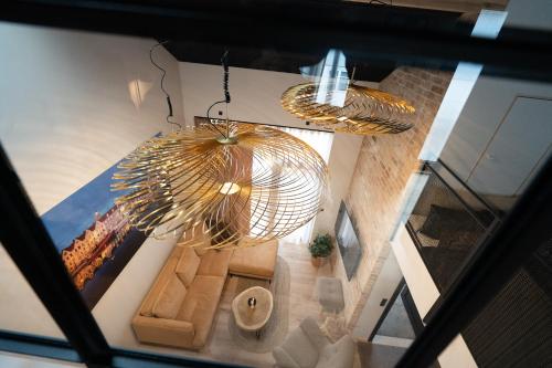 an overhead view of a living room with two chandeliers at Lonin - Brand New Premium Apartment in the heart of Tórshavn in Tórshavn