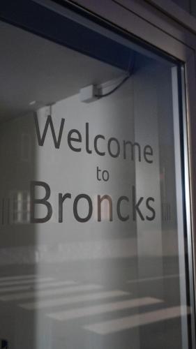 a window with a welcome to bronzes sign on it at Broncks Lonin - Luxury Apartments in the Heart of Tórshavn in Tórshavn
