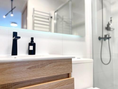 a bathroom with a white sink and a shower at Departamento Centro moderno con balcón in Temuco