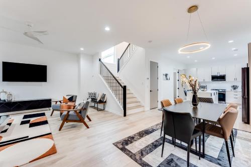 a living room with a dining room table and a kitchen at Modern Luxury In The City at Havilah Estates in Atlanta