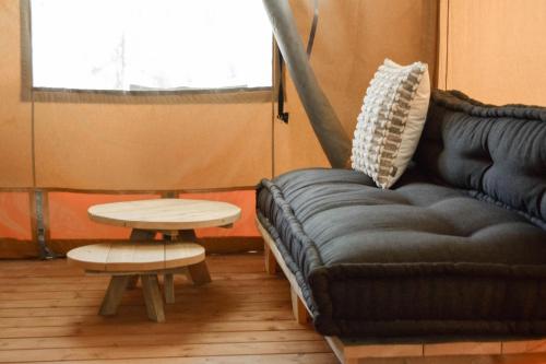 a living room with a couch and a table at Koondrook Glamping Retreat in Koondrook