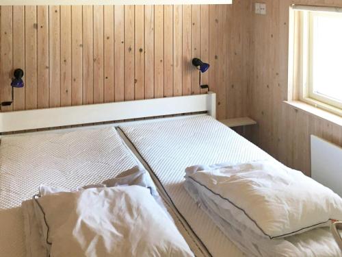 due letti in una stanza con pareti in legno di 6 person holiday home in Rødby a Rødby