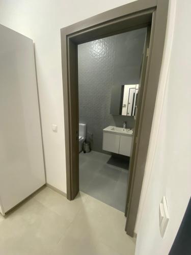 uma casa de banho com um espelho e um lavatório branco em Studio Moderne et Élégant Gallo 4 - Mamelles Dakar em Dakar