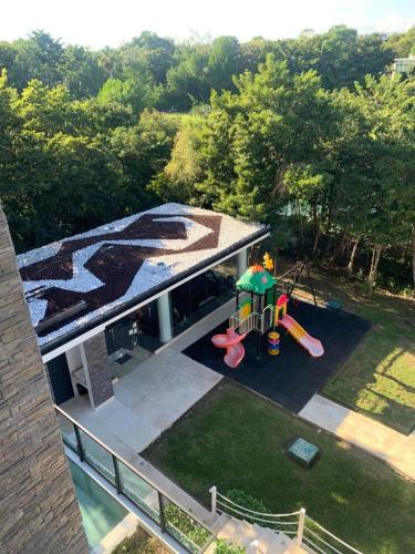 an aerial view of a backyard with a playground at LUXURY spacious Condo Option with 1 or 2 or 3 Bedrooms, PGA Golf, Gym, Kay Beach Club in Kaan Ha Akumal in Akumal