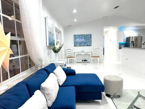 a living room with a blue and white couch at Home in Miami in Miami