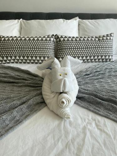 a stuffed animal is laying on a bed at LUXURY spacious Condo Option with 1 or 2 or 3 Bedrooms, PGA Golf, Gym, Kay Beach Club in Kaan Ha Akumal in Akumal