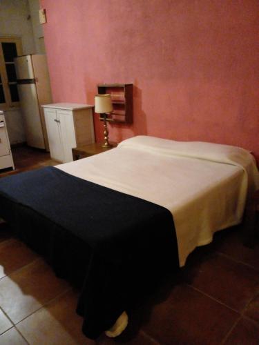 a bedroom with a large bed in a room at Dormi en Mar del Plata! in Mar del Plata