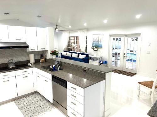 a kitchen with white cabinets and a counter top at Home in Miami in Miami