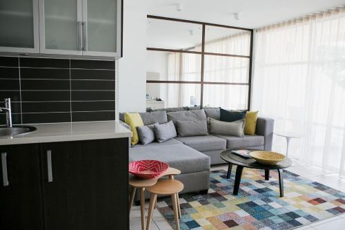 a living room with a couch and a table at Netanya Noosa Beachfront Resort in Noosa Heads