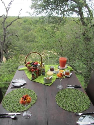 a picnic table with a basket of food on it at Greenfire Game Lodge in Balule Game Reserve