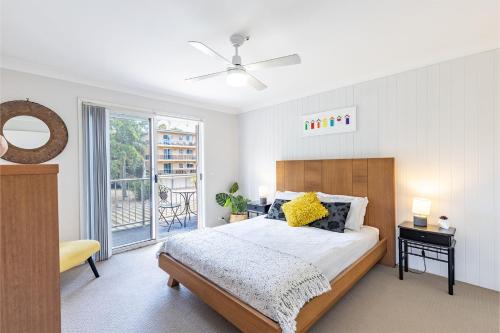 a bedroom with a bed and a large window at 110 Catalina Close so close to the water in Shoal Bay