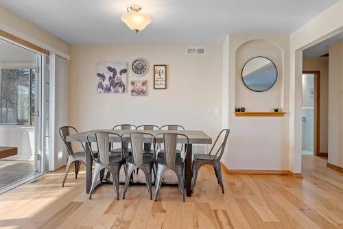 a dining room with a table and chairs at Unique 4 Season Porch 6 Queen Beds HUGE Space in Rapid City