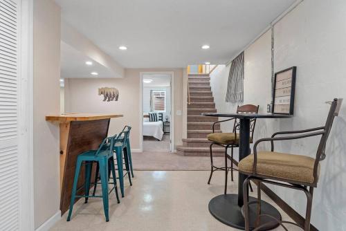 a room with chairs and a table and a staircase at Unique 4 Season Porch 6 Queen Beds HUGE Space in Rapid City