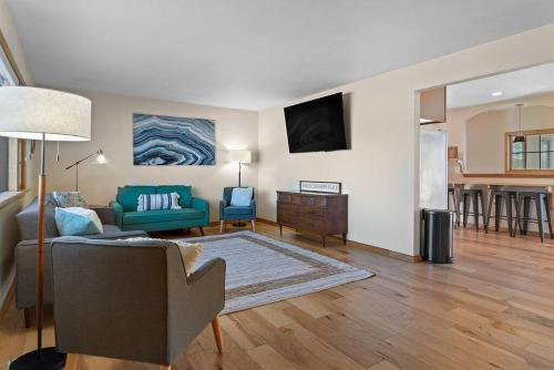 a living room with a couch and a table at Unique 4 Season Porch 6 Queen Beds HUGE Space in Rapid City
