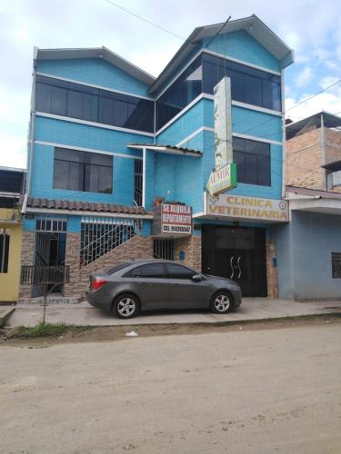 a car parked in front of a blue building at Piso de 2 camas in Moyobamba