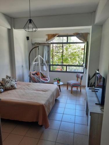 a bedroom with a large bed and a swing at Pleno centro in San Juan