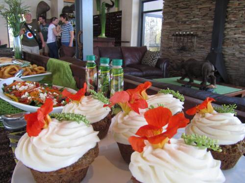 a group of cupcakes with flowers on them on a table at Greenfire Game Lodge in Balule Game Reserve