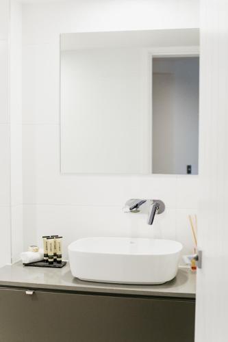 a white sink on a counter in a bathroom at Netanya Noosa Beachfront Resort in Noosa Heads