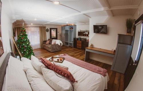 a living room with a christmas tree and a white couch at The Free Spirit Retreat in Newaygo