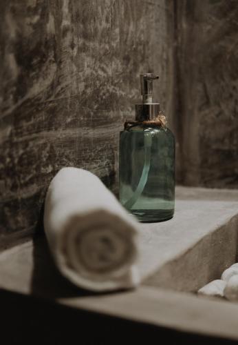 a bottle of soap sitting on a bathroom sink at BOA BOA Bacalar in Bacalar