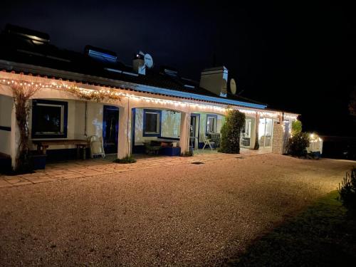 a house with lights on the side of it at night at Inviting holiday home in Montemor o Novo with Pool in Montemor-o-Novo