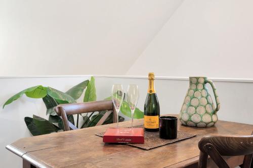 a table with a bottle of wine and two glasses at The Barn in Kangaroo Valley