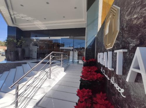 a building with red flowers on the side of it at Hotel GRALTA in Jalostotitlán