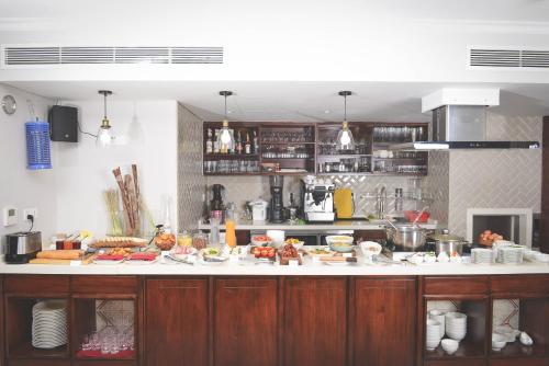 a kitchen with a counter with food on it at Maison De Camille Boutique Hotel in Ho Chi Minh City