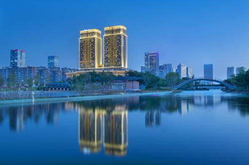 a view of a city skyline with a river and buildings at Oakwood Residence Foshan in Foshan