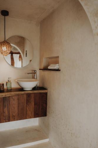 a bathroom with a sink and a mirror at BOA BOA Bacalar in Bacalar