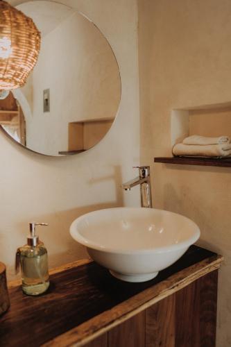 a bathroom with a white sink and a mirror at BOA BOA Bacalar in Bacalar