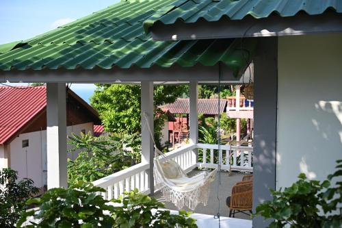 a view from the balcony of a house with a hammock at Bao Village in Haad Yao