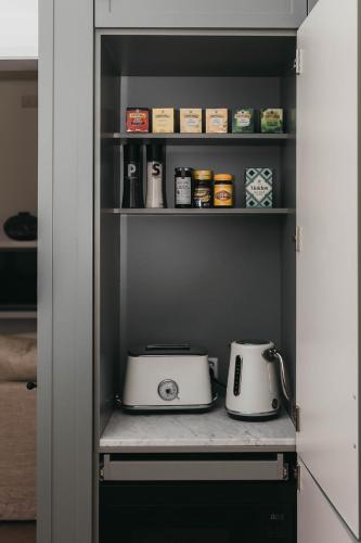a kitchen with two toasters on a shelf at Mopsy's On The Esplanade in Wagga Wagga