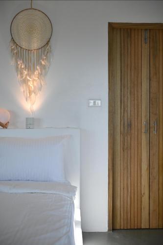 a bedroom with a bed and a chandelier next to a door at Bao Village in Haad Yao