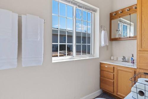 a bathroom with a sink and a window at Unique Barn Stay Close to The Hills in Rapid City