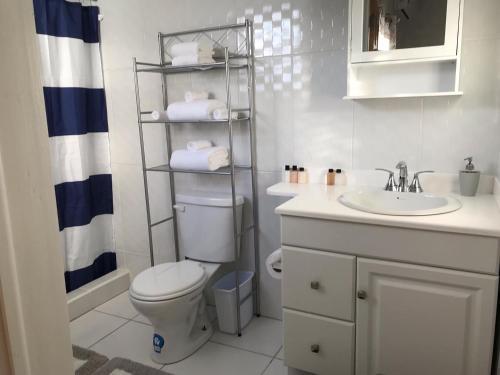 a bathroom with a toilet and a sink at Compassionate Touch Spa in Newcastle Village