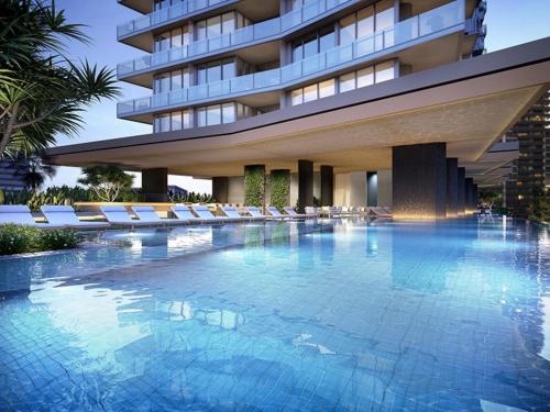 a large swimming pool in front of a building at Signature Broadbeach Ocean Views Apartment - CoastHM in Gold Coast