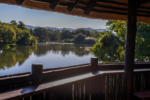 a view of a lake from the porch of a cabin at Kruger Park Lodge Unit No. 241 in Hazyview