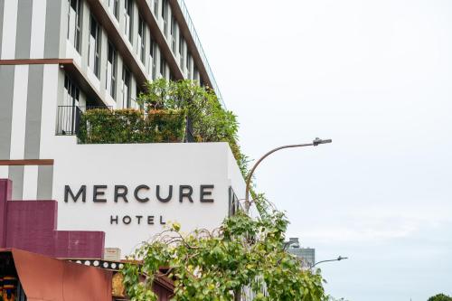a sign for a morgue hotel on the side of a building at Mercure Singapore Tyrwhitt in Singapore