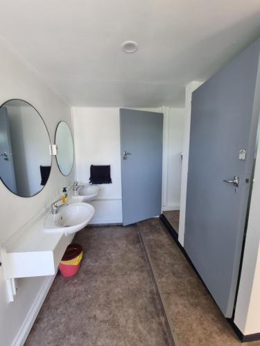 a bathroom with two sinks and a mirror at Cheviot Motels, Cabins and Camp in Cheviot